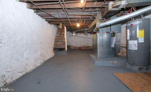 basement featuring heating unit and water heater