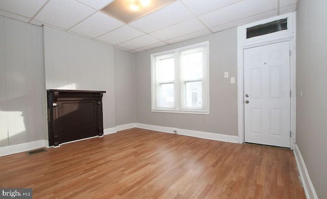 foyer entrance featuring a paneled ceiling and light hardwood / wood-style floors