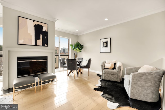 living room with light hardwood / wood-style floors and ornamental molding