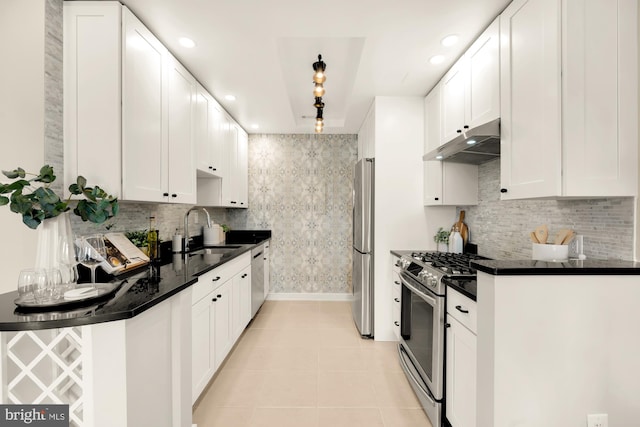 kitchen with white cabinetry, stainless steel appliances, tasteful backsplash, sink, and light tile patterned floors