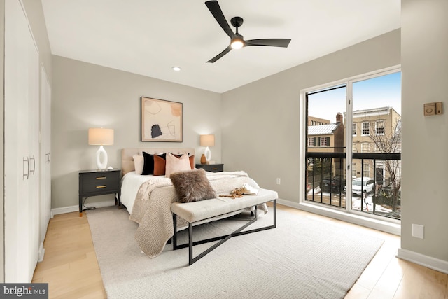 bedroom with ceiling fan and light hardwood / wood-style flooring