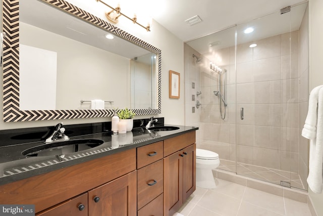 bathroom with vanity, toilet, an enclosed shower, and tile patterned flooring