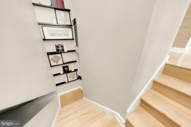 stairs with hardwood / wood-style flooring