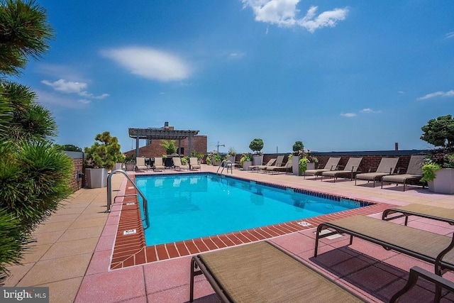 view of pool with a patio and a pergola