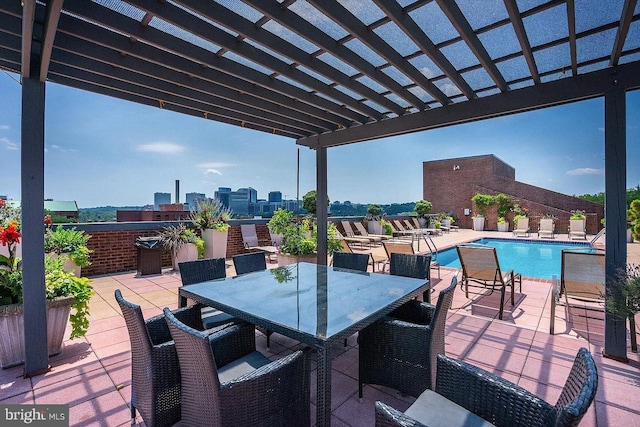 view of patio with a community pool and a pergola