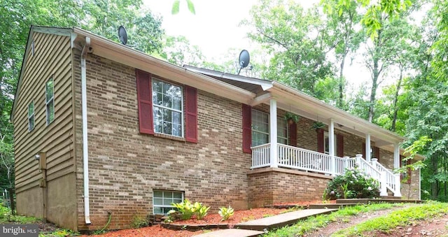 view of property exterior featuring covered porch