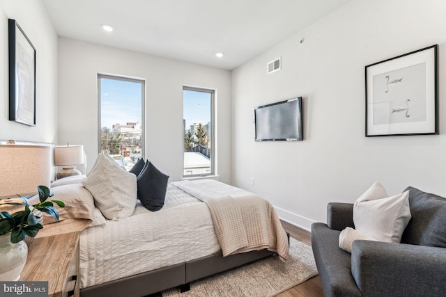 bedroom with hardwood / wood-style flooring