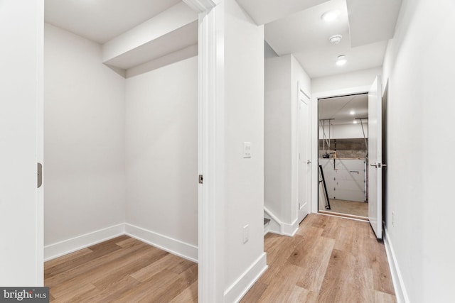 corridor with light hardwood / wood-style flooring