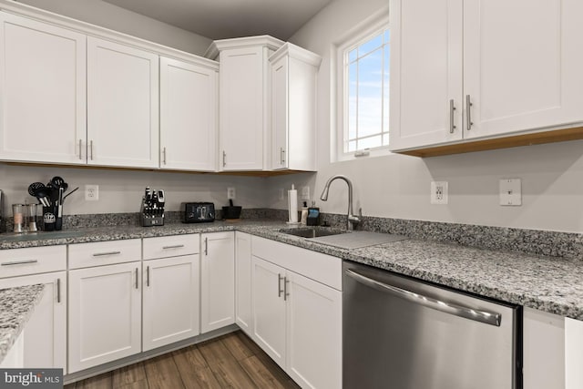 kitchen featuring light stone counters, sink, white cabinets, and dishwasher