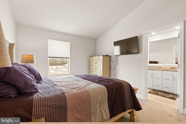 carpeted bedroom featuring connected bathroom and lofted ceiling