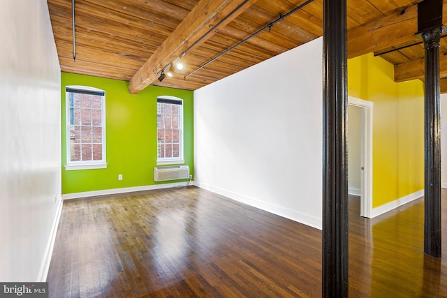 spare room with dark wood-type flooring, track lighting, wooden ceiling, and beam ceiling