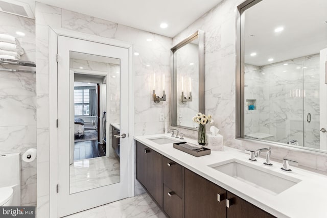 bathroom featuring an enclosed shower, vanity, tile walls, and toilet