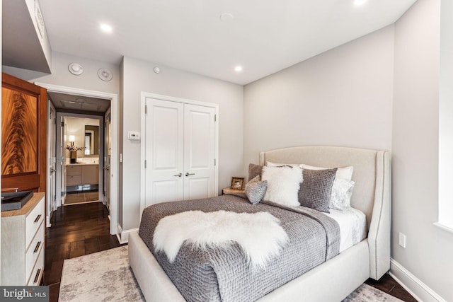 bedroom featuring dark wood-type flooring and a closet