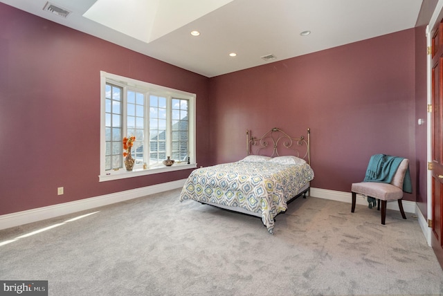 carpeted bedroom with a skylight