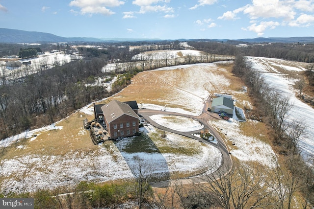 snowy aerial view with a mountain view