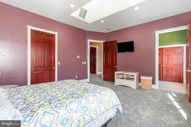 bedroom with light colored carpet and a skylight