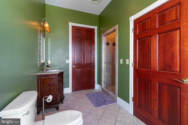 bathroom with vanity, tile patterned floors, a shower with door, and toilet