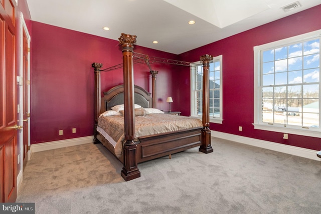 carpeted bedroom with multiple windows