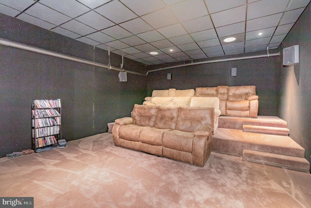 home theater with carpet floors and a paneled ceiling