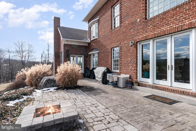 view of patio / terrace with french doors, grilling area, and a fire pit