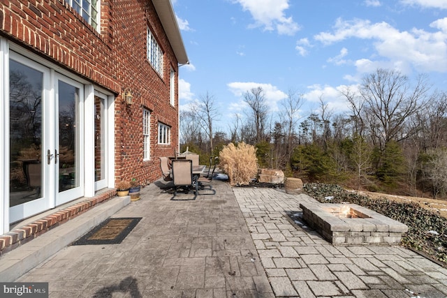 view of patio featuring french doors and a fire pit