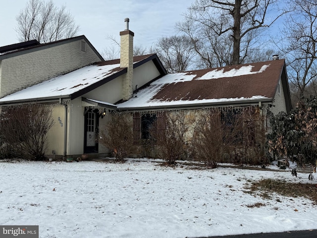 view of snow covered back of property