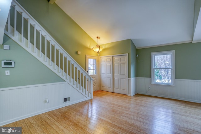 entryway featuring light hardwood / wood-style flooring and vaulted ceiling