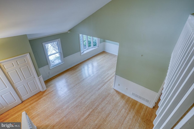 interior space with vaulted ceiling and light hardwood / wood-style floors