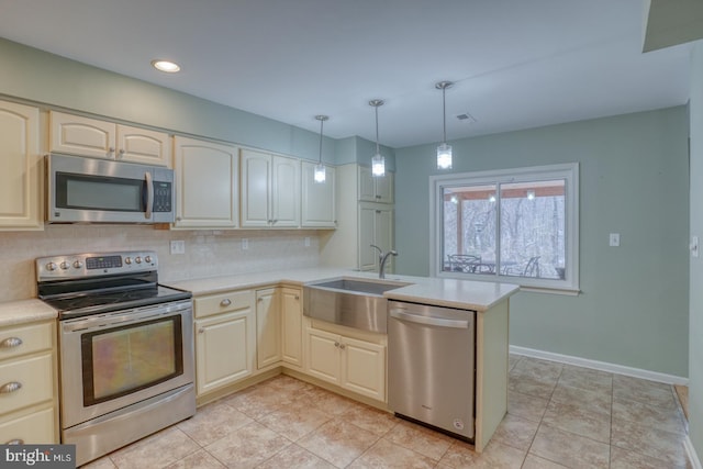 kitchen with sink, hanging light fixtures, light tile patterned floors, kitchen peninsula, and stainless steel appliances