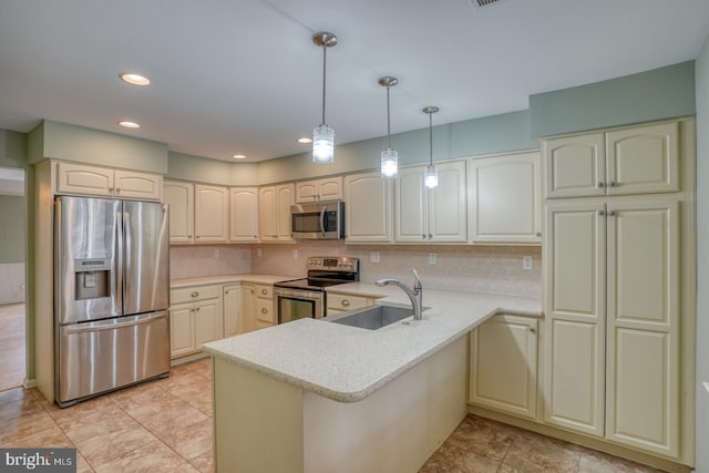 kitchen featuring sink, hanging light fixtures, kitchen peninsula, stainless steel appliances, and backsplash