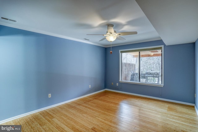 spare room with crown molding, light hardwood / wood-style flooring, and ceiling fan