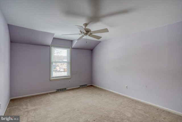 carpeted empty room with ceiling fan and lofted ceiling