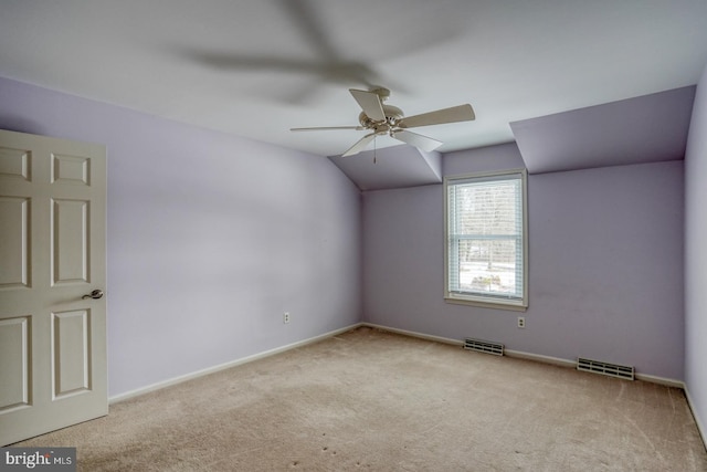 unfurnished room with light carpet, vaulted ceiling, and ceiling fan