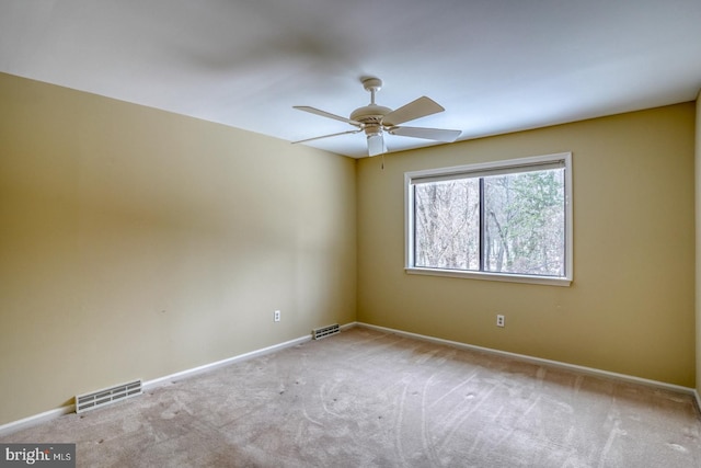 spare room featuring ceiling fan and light carpet