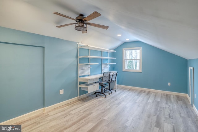 unfurnished office with ceiling fan, lofted ceiling, and light wood-type flooring