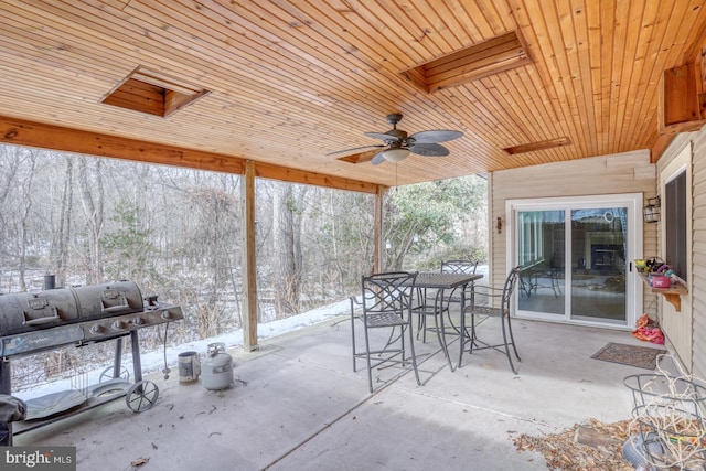 snow covered patio with a grill and ceiling fan