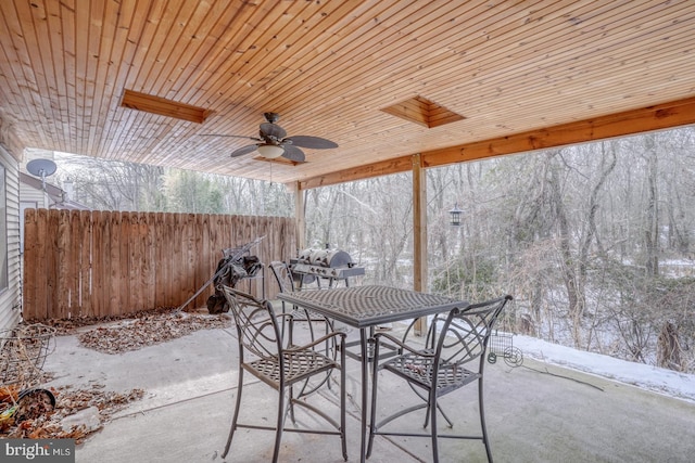 snow covered patio featuring ceiling fan