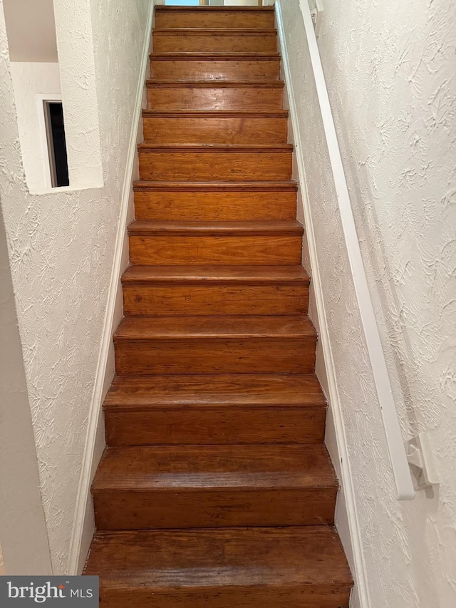 staircase with a textured wall