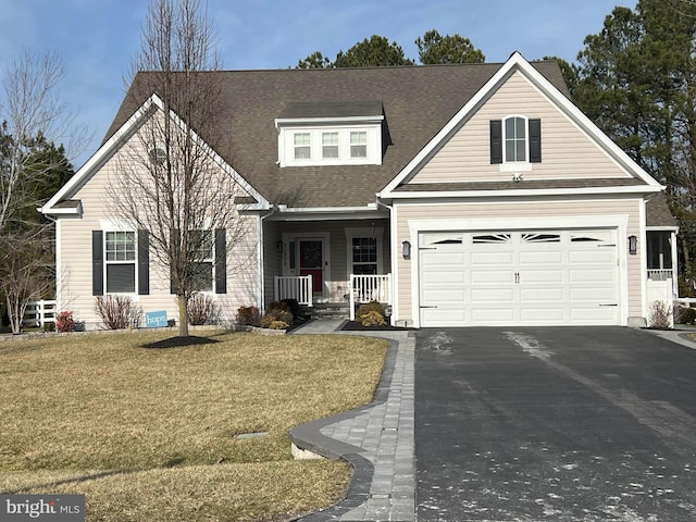 view of front facade with a garage, covered porch, and a front yard