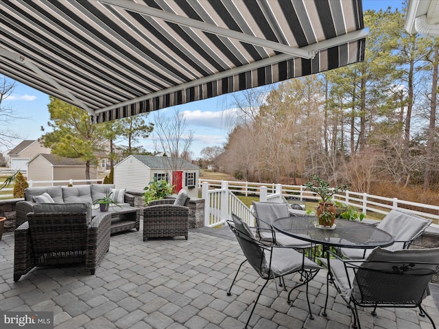 view of patio featuring an outbuilding and an outdoor living space