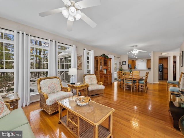 living room featuring light hardwood / wood-style flooring and ceiling fan