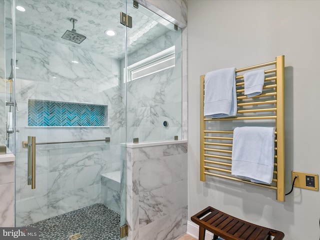 bathroom featuring radiator and walk in shower