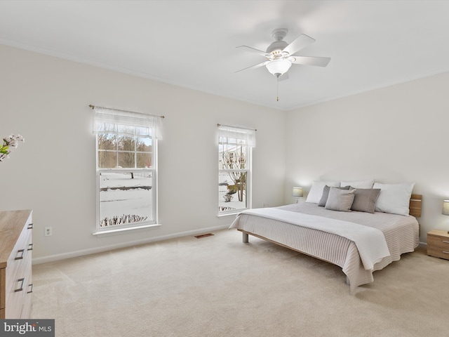 bedroom with ceiling fan and light colored carpet