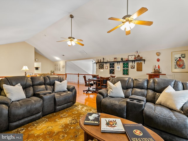 living room with hardwood / wood-style flooring, lofted ceiling, and ceiling fan