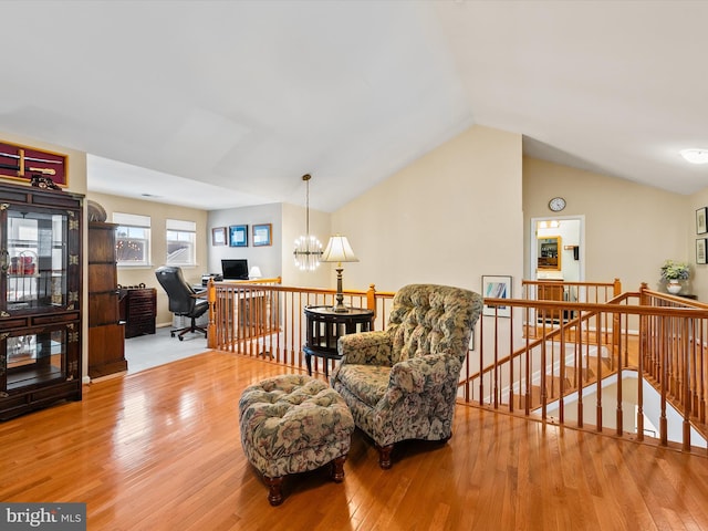 sitting room featuring lofted ceiling, a notable chandelier, and light hardwood / wood-style floors