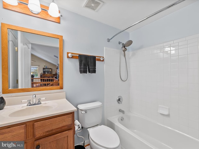 full bathroom with vanity, tiled shower / bath combo, and toilet