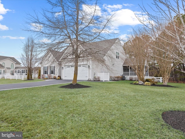 exterior space with a garage and a lawn