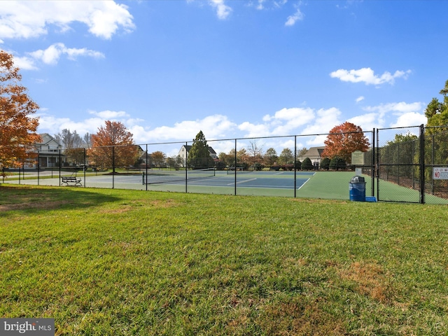 view of sport court featuring a yard