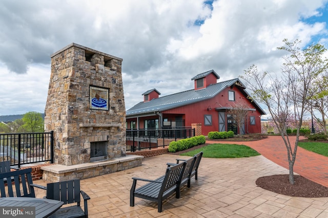 view of patio featuring an outdoor stone fireplace