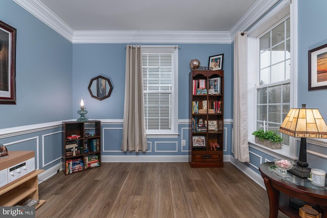 sitting room featuring ornamental molding and dark hardwood / wood-style floors